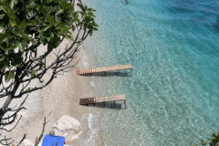 A-beach-with-a-few-chairs-and-a-few-trees