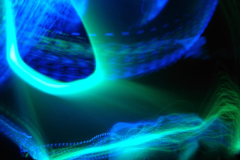 A-blue-and-green-light-is-shining-on-a-black-background