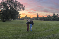 A-couple-of-people-standing-in-a-field