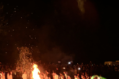 A-group-of-people-gathered-around-a-fire
