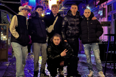 A-group-of-people-standing-on-a-cobbles