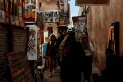 A-group-of-people-walking-down-a-narrow-alley