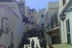 A-group-of-people-walking-down-a-narrow-street
