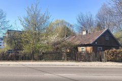A-house-with-a-fence-in-front-of-it