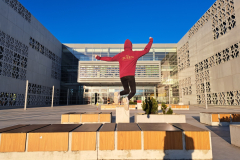 A-man-jumping-in-the-air-in-front-of-a-building