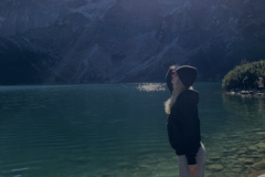 A-man-standing-on-a-rock-looking-at-a-lake