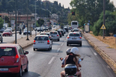 A-person-riding-a-motorcycle-down-a-street