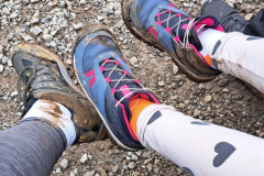 A-person-wearing-a-pair-of-shoes-on-a-rocky-trail