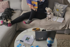 A-woman-sitting-on-a-couch-reading-a-book