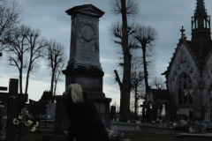 A-woman-standing-in-front-of-a-cemetery