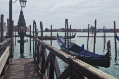 A-wooden-dock-with-boats-docked-in-the-water