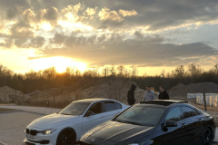 Two-cars-parked-on-a-street-with-a-man-standing-on-the-side