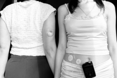 Two-women-in-white-dresses-are-standing-next-to-each-other-women