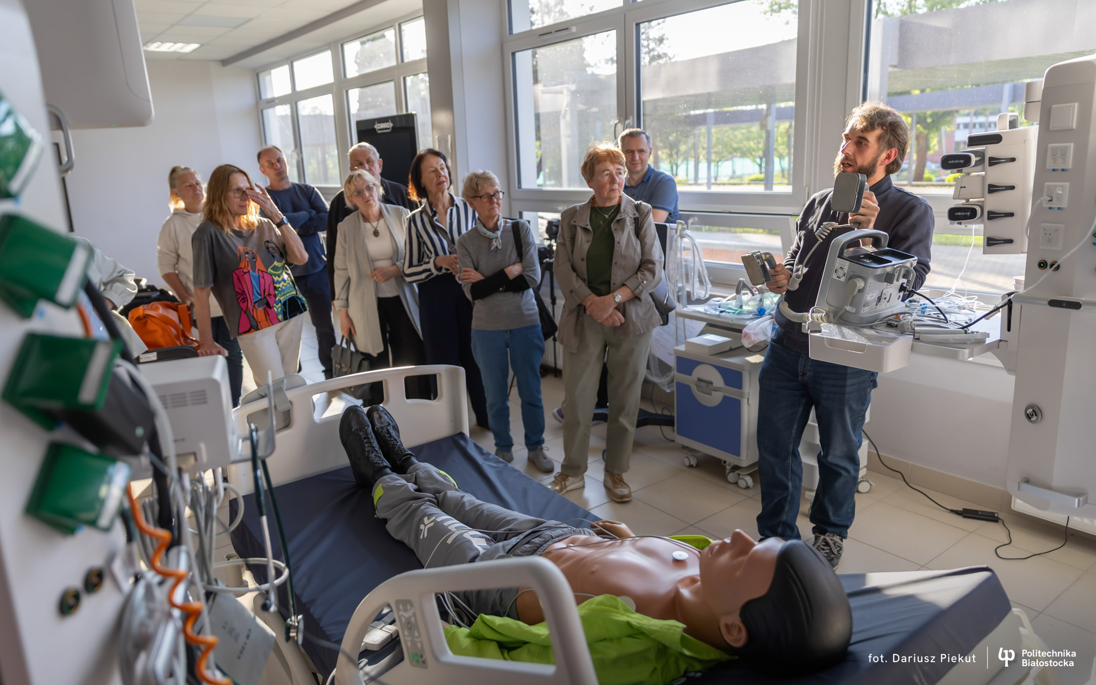 seniorzy skupieni wokół aparatury w laboratorium